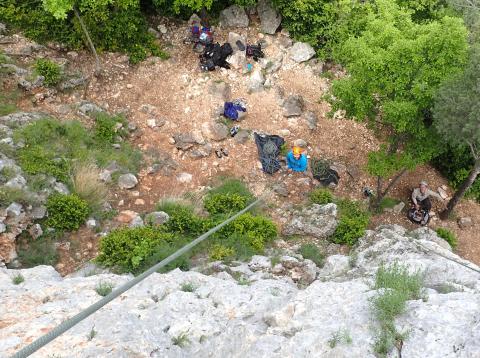 Photo : vue du haut de la falaise sur les assureurs en escalade